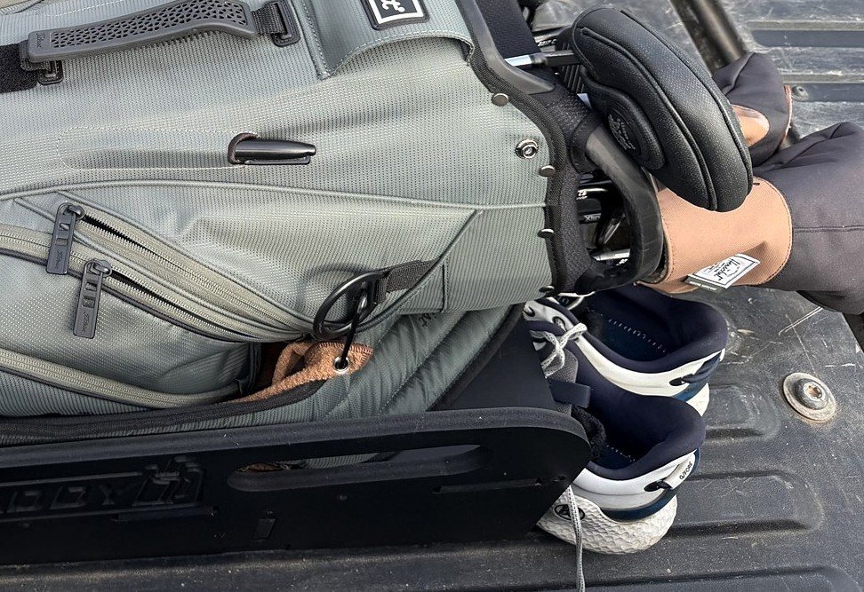 Real golf shoes stored in the lower Truck Caddy compartment